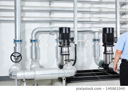 Industrial pump system with large metal pipes and electrical motors Industrial pump system with large metal pipes and electrical motors 140861040