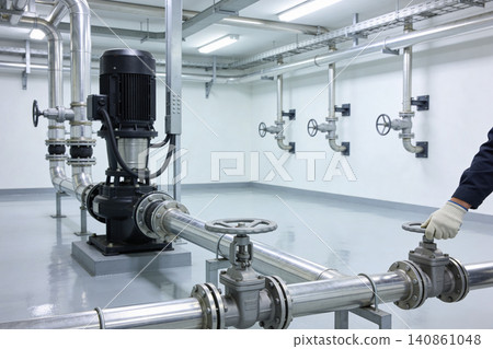 Industrial pump and valve system in a clean, modern facility with bright lighting Industrial pump and valve system in a clean, modern facility with bright lighting 140861048