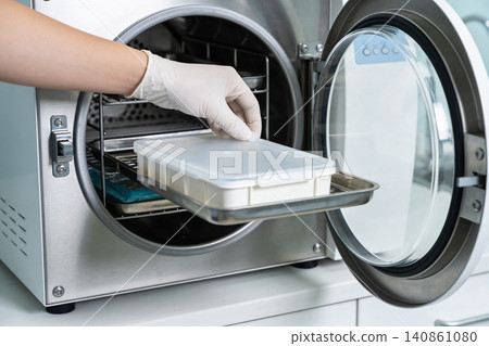 Sterilization process: placing medical instruments in an autoclave for disinfection Sterilization process: placing medical instruments in an autoclave for disinfection 140861080