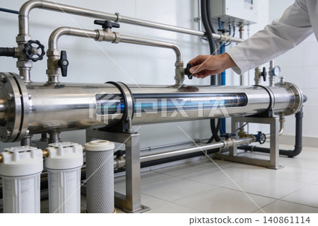 Industrial UV water purification system with technician adjusting controls Industrial UV water purification system with technician adjusting controls 140861114
