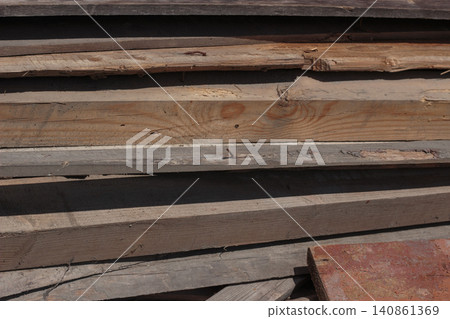 Stack of old weathered wooden boards with nails 140861369