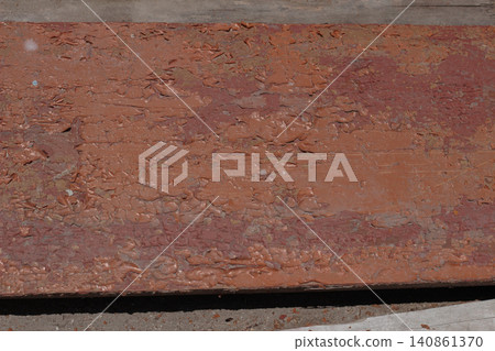 Close-up of old peeling brown paint on wooden board Close-up of old peeling brown paint on wooden board 140861370