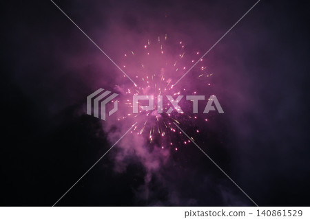 Vivid Purple Pink Fireworks Explosion Bursting Against Dark Night Sky with Smoke Vivid Purple Pink Fireworks Explosion Bursting Against Dark Night Sky with Smoke 140861529