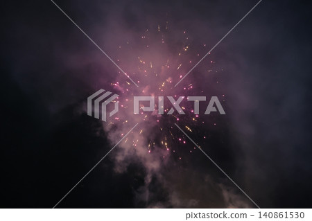 Vivid Purple Pink Fireworks Explosion Bursting Against Dark Night Sky with Smoke Vivid Purple Pink Fireworks Explosion Bursting Against Dark Night Sky with Smoke 140861530