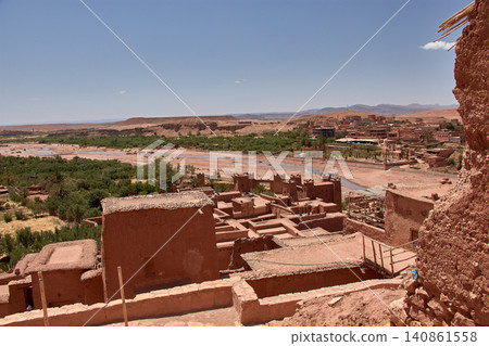 The Ksar of Ait Benhaddou rises majestically above the desert valley of Ouarzazate, Morocco. The Ksar of Ait Benhaddou rises majestically above the desert valley of Ouarzazate, Morocco. 140861558
