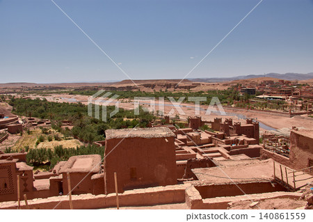 The Ksar of Ait Benhaddou rises majestically above the desert valley of Ouarzazate, Morocco. The Ksar of Ait Benhaddou rises majestically above the desert valley of Ouarzazate, Morocco. 140861559