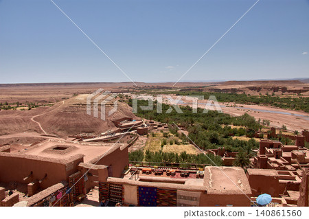 The Ksar of Ait Benhaddou rises majestically above the desert valley of Ouarzazate, Morocco. The Ksar of Ait Benhaddou rises majestically above the desert valley of Ouarzazate, Morocco. 140861560
