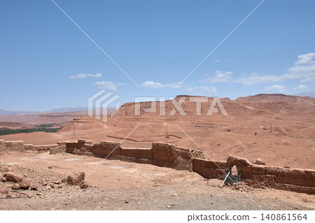 The Ksar of Ait Benhaddou rises majestically above the desert valley of Ouarzazate, Morocco. The Ksar of Ait Benhaddou rises majestically above the desert valley of Ouarzazate, Morocco. 140861564
