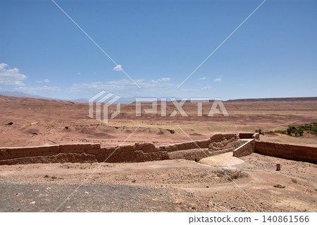 The Ksar of Ait Benhaddou rises majestically above the desert valley of Ouarzazate, Morocco. The Ksar of Ait Benhaddou rises majestically above the desert valley of Ouarzazate, Morocco. 140861566