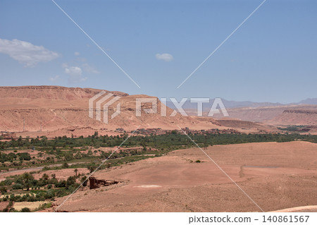 The Ksar of Ait Benhaddou rises majestically above the desert valley of Ouarzazate, Morocco. The Ksar of Ait Benhaddou rises majestically above the desert valley of Ouarzazate, Morocco. 140861567
