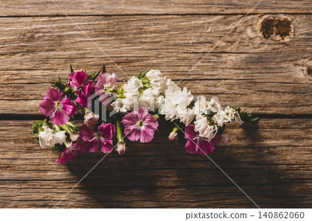 Blooming Flowers Emerging Between Wooden Planks. Blooming Flowers Emerging Between Wooden Planks. 140862060