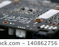 Macro close-up of a graphics card printed circuit board with electronic components, microchips and surface mount devices. Technology, computing and hardware concept 140862756