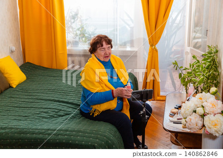 Elderly Caucasian woman creating beauty content while presenting skincare products to an online audience. Cosmetic influencer concept. Active retirement and modern digital communication. Top view Elderly Caucasian woman creating beauty content while presenting skincare products to an online audience. Cosmetic influencer concept. Active retirement and modern digital communication. Top view 140862846