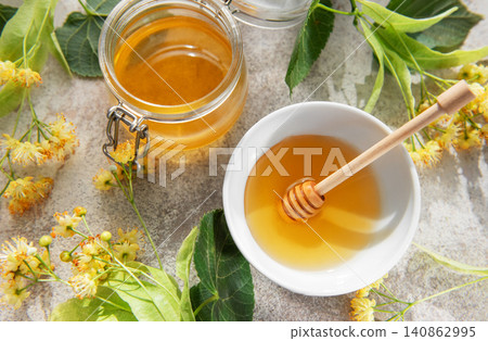 Linden honey jar and bowl with fresh flowers Linden honey jar and bowl with fresh flowers 140862995