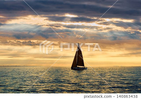 A lot of sailing boats are in sailing regatta in the Gulf of Finland at sunset, Russia, St.Petersburg, hot race of several yachts, teamwork, yachtsman A lot of sailing boats are in sailing regatta in the Gulf of Finland at sunset, Russia, St.Petersburg, hot race of several yachts, teamwork, yachtsman 140863438