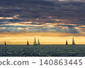 A lot of sailing boats are in sailing regatta in the Gulf of Finland at sunset, Russia, St.Petersburg, hot race of several yachts, teamwork, yachtsman 140863445