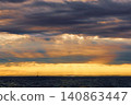 incredible reflection on the water at sunset, Yachtsmen are sitting amicably on board the boat, sailing boat is in sailing regatta in the Gulf of Finland at sunset, hot race, teamwork 140863447