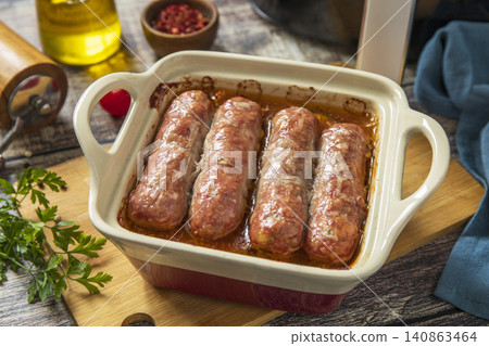 Hearty grilled sausages baked with vegetables on wooden background. Healthy cooking with air fryer. Lifestyle trendy of new cooking. Hearty grilled sausages baked with vegetables on wooden background. Healthy cooking with air fryer. Lifestyle trendy of new cooking. 140863464