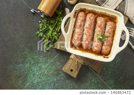 Grilled sausages baked with vegetables on a stone countertop. Healthy eating, quick cooking. Comfort food meal. Top view flat lay background. 140863472