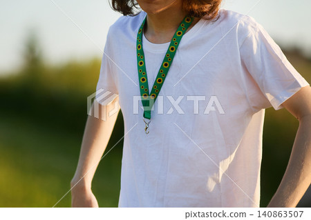 Person wearing sunflower lanyard indicating hidden disability awareness Person wearing sunflower lanyard indicating hidden disability awareness 140863507