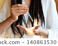 Woman Applying Hair Serum With Glass Dropper During Beauty Routine, Healthy Hair, Home Self Care And Premium Beauty Concept 140863530