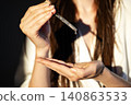 Woman Applying Facial Serum With Glass Dropper During Skincare Routine, Beauty Treatment, Healthy Skin, Daily Self Care And Premium Cosmetic Concept 140863533
