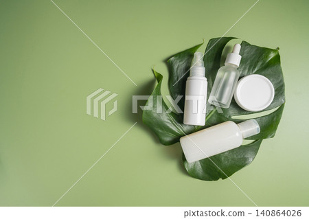 Natural skincare products on monstera leaf with green background, botanical clean beauty concept Natural skincare products on monstera leaf with green background, botanical clean beauty concept 140864026