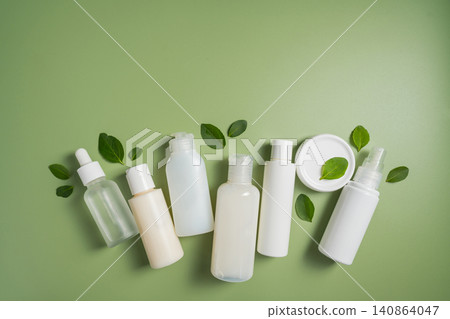 Natural skincare products with botanical leaves on green background, clean beauty cosmetic collection mockup Natural skincare products with botanical leaves on green background, clean beauty cosmetic collection mockup 140864047