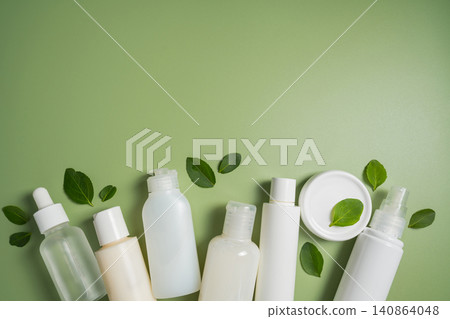 Natural skincare products with botanical leaves on green background, clean beauty cosmetic collection mockup Natural skincare products with botanical leaves on green background, clean beauty cosmetic collection mockup 140864048