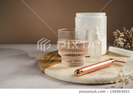 Woman adding collagen supplement to glass of water, self care product. Copy space Woman adding collagen supplement to glass of water, self care product. Copy space 140864081