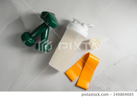 Home workout essentials with protein powder and shaker bottle Home workout essentials with protein powder and shaker bottle 140864085