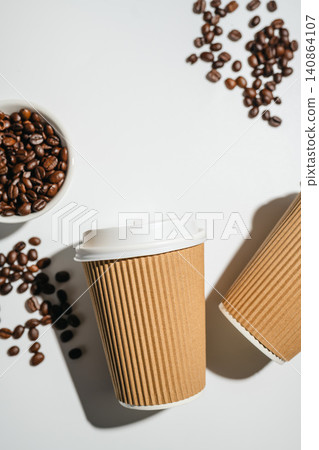 Takeaway coffee cups and roasted coffee beans on white background with copy space, flat lay 140864107