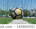 Soccer Ball on the Goal Line with Net in the Background 140864581