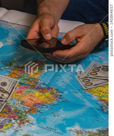 Planning a travel budget using a map and a smartphone for a trip Planning a travel budget using a map and a smartphone for a trip 140864657