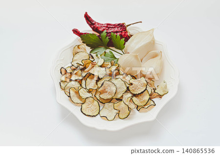 Dried zucchini served on a white plate 140865536