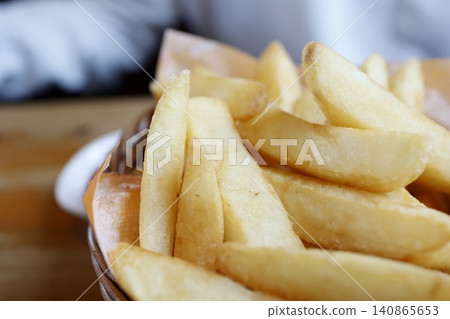 French fries. One serving. Close-up. Crispy, golden-brown fries. French fries. One serving. Close-up. Crispy, golden-brown fries. 140865653