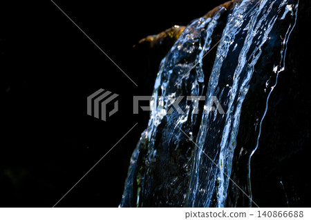 A small waterfall against a black background A small waterfall against a black background 140866688