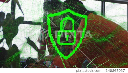 Leaning duo using pc behind glass windows orange-tee and patterned neon-lock wireframe, plant left Leaning duo using pc behind glass windows orange-tee and patterned neon-lock wireframe, plant left 140867037