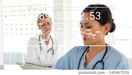 Reviewing nurse in blue scrubs checking clipboard and writing in clinic, with stethoscope and HUD Reviewing nurse in blue scrubs checking clipboard and writing in clinic, with stethoscope and HUD 140867039