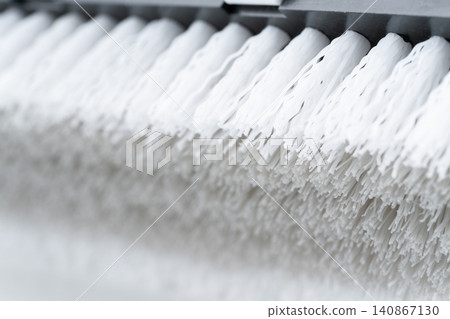 Close-up of the head of a white and gray deck brush. Close-up of the head of a white and gray deck brush. 140867130