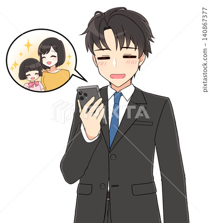 A young, handsome man in a suit grins as he looks at a family photo. A young, handsome man in a suit grins as he looks at a family photo. 140867377