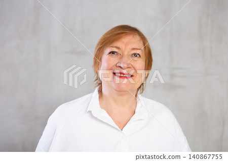 Closeup portrait of smiling older woman in white shirt Closeup portrait of smiling older woman in white shirt 140867755