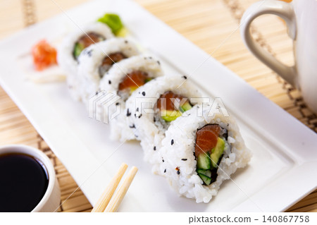 Sake roll with salmon, avocado and cucumber Sake roll with salmon, avocado and cucumber 140867758