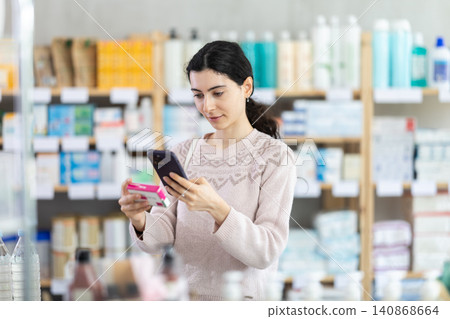 Young woman scanning qr code of paracetamol Young woman scanning qr code of paracetamol 140868664
