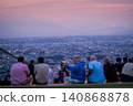 Silhouettes of people on an observation deck overlooking the city at dusk 140868878