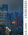 The vibrant Tokyo Tower and skyscrapers stand out against the night sky. 140868880
