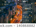 Light trails from the highway winding through the city center at night 140868882