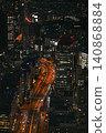 The lights of the highway stretch through the city streets at night. 140868884