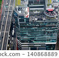 High-rise building with a highway and rooftop terrace (daytime) 140868889