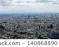 The densely packed cityscape of Tokyo and the Tokyo Skytree under a cloudy sky. 140868890